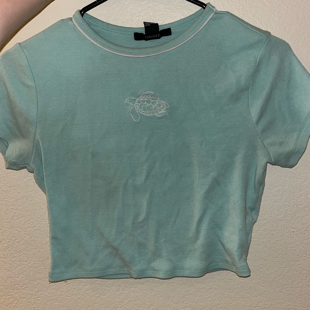 Aqua blue crop top with white turtle design